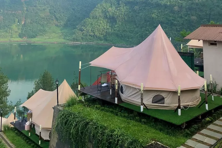 Pemandangan The Heaven Glamping & Resto di Wonosobo dengan tenda glamping yang mewah di tengah perbukitan hijau dan langit biru cerah, menawarkan pengalaman menginap yang unik dan dekat dengan alam.